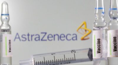 FILE PHOTO: A test tube labelled with the Vaccine is seen in front of AstraZeneca logo in this illustration taken