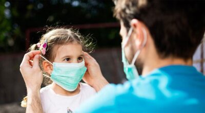 single-father-applying-mask-on-daughter